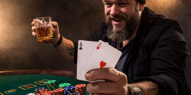 Man drinking while playing poker
