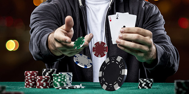 Overhead view of players playing at a poker table with Everygame Poker written on it 