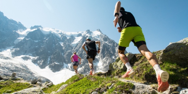 Runners competing to reach a mountain peak. 