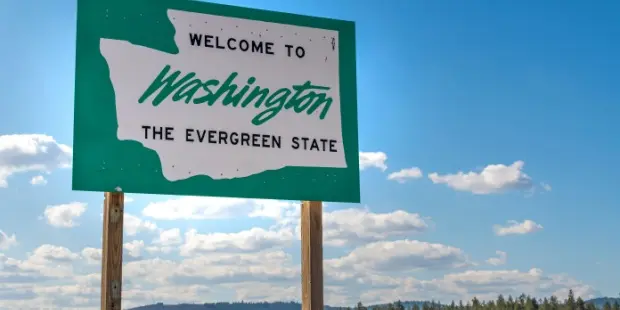 A roadside sign welcoming people to Washington State. 