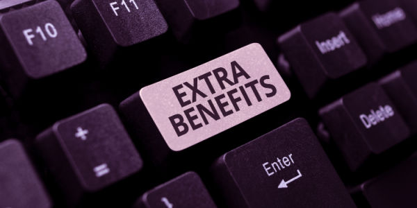 The words 'extra benefits' printed on a keyboard.