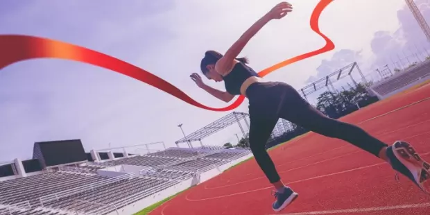 A woman crossing the finish line in a race. 