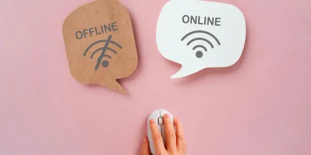 A man holding a computer mouse, choosing between speech bubbles that say "online" and "offline". 
