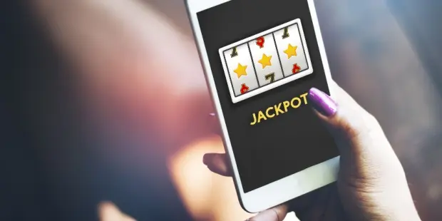 A woman hitting the jackpot while playing slots on her smartphone