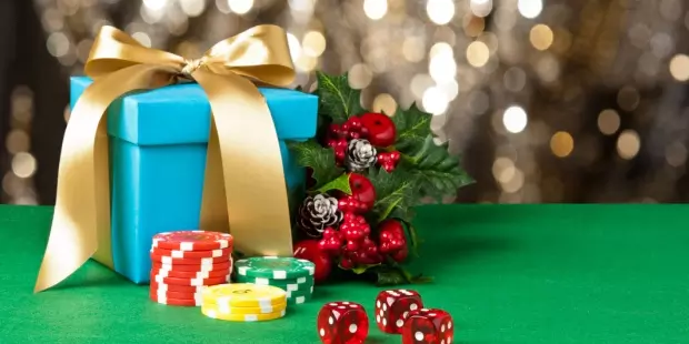 Garland, a gift box, and poker chips lying on a poker table. 