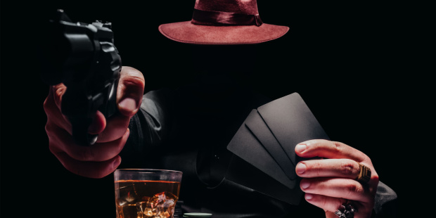 A shaded poker player pointing a gun at his opponents.