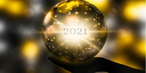hand holding a golden crystal ball and 2021 written on it