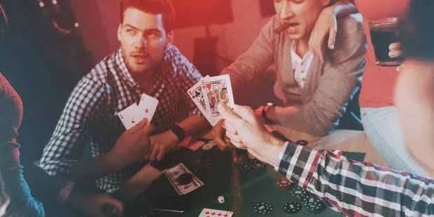 People playing poker at a poker table.