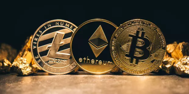 Three golden crypto coins lined up in a row: Bitcoin, Ethereum, and Litecoin.