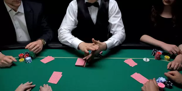 People playing poker at a poker table.