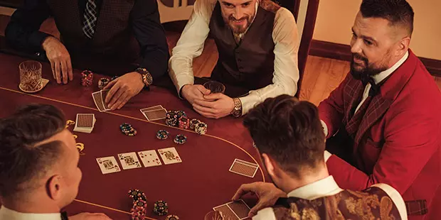 People playing poker at a poker table.