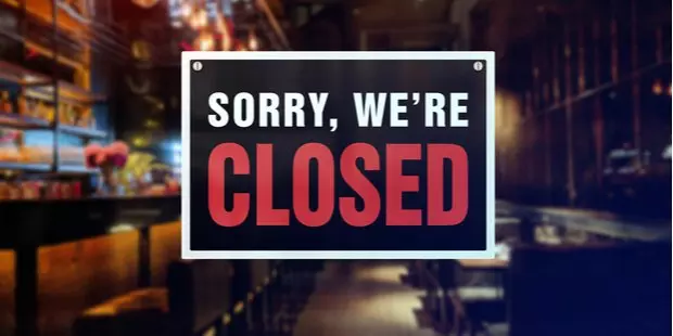 A "sorry, we're closed" sign posted at the entrance of a restaurant. 