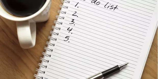 a To Do list with a cup of coffee and mobile phone next to it