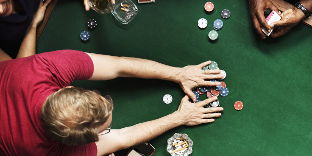 People playing poker at a poker table.