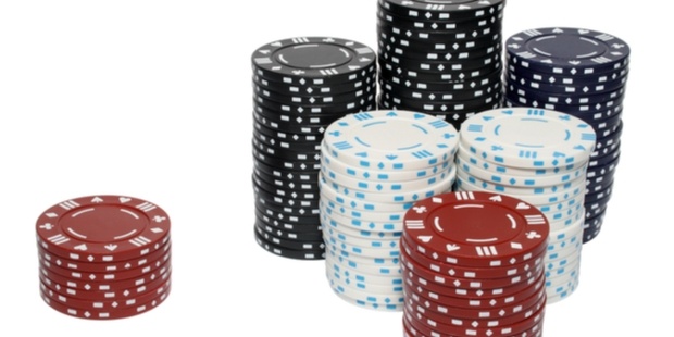 a large stack of poker chips next to a smaller stack