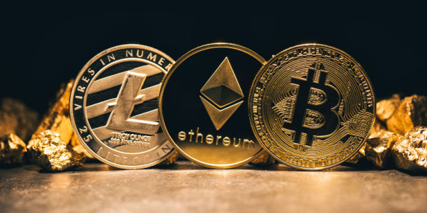 Three golden crypto coins lined up in a row: Bitcoin, Ethereum, and Litecoin.