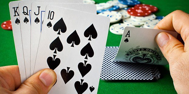 man holding cards and playing poker