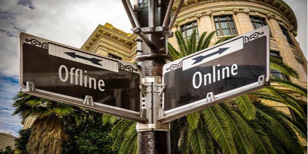 An "online" street sign facing the opposite direction of an "offline" sign.