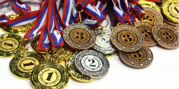 An image of a pile of medals, gold, silver, and bronze.