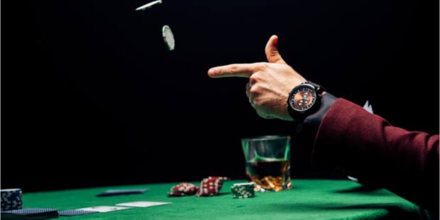 An image of a player throwing poker chips in the air. 