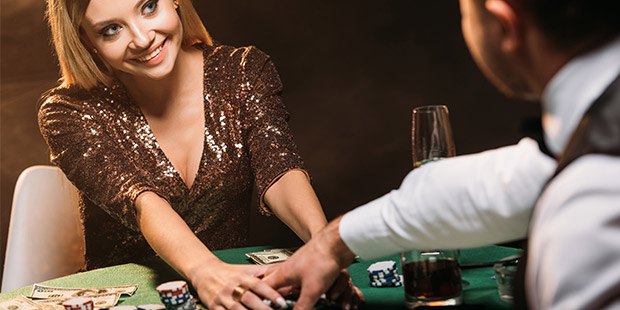 Poker player smiling as opponent takes the pot