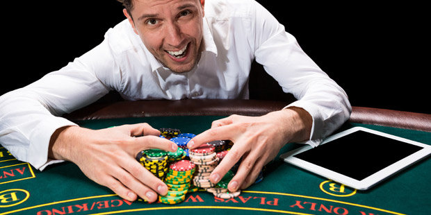 A poker player with a big pile of chips in front of him.