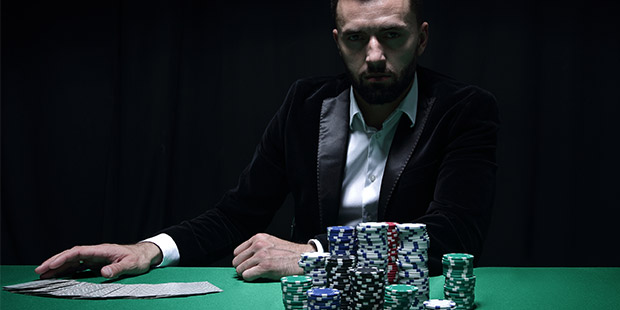 player examining coins in the center of the table
