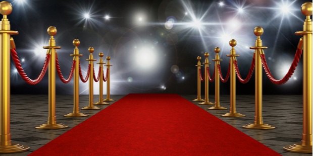 red carpet leading up to bright lights