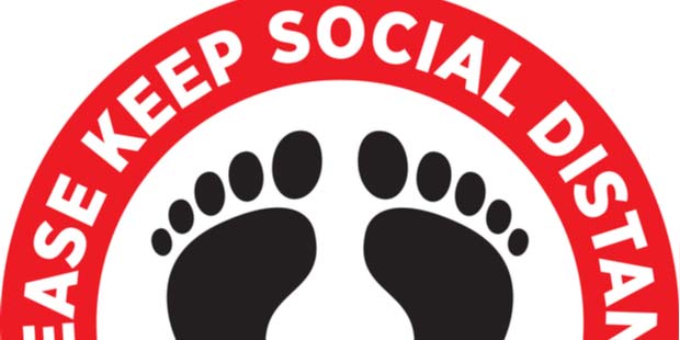 A picture of a red social distancing floor sticker. 