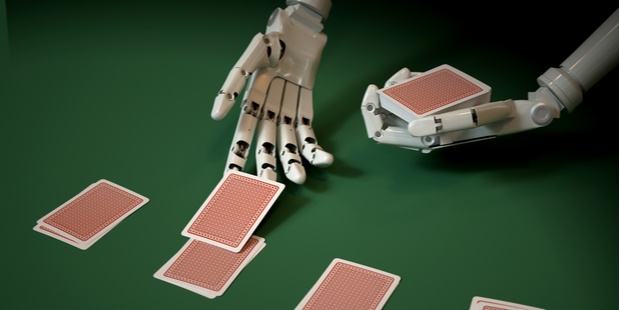 robotic hand holding cards