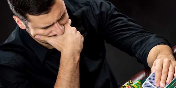 A poker player with furrowed brow in deep contemplation