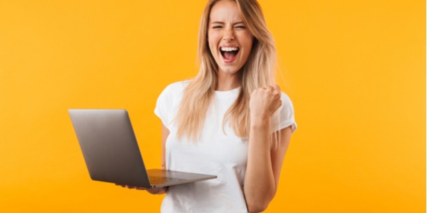 woman holding her laptop and happy about a win at Everygame Poker on a yellow background