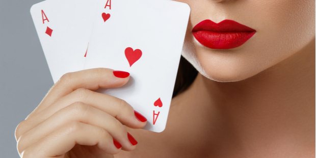 A photo of a woman showing her hand with 2 aces